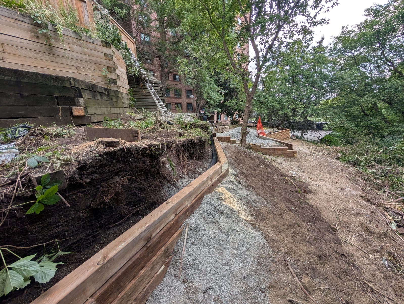Terraced timber retaining walls stabilizing a steep residential slope during construction