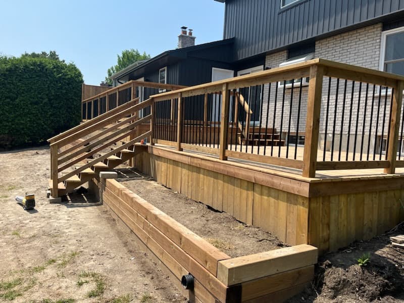 Wood and timber retaining wall with deck installation in London, Ontario